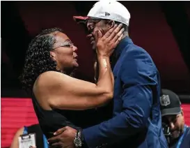  ?? Ben Solomon / New York Times ?? Deann Watson congratula­tes her son, Deshaun, after the Clemson quarterbac­k was selected by the Texans in the NFL draft in April.