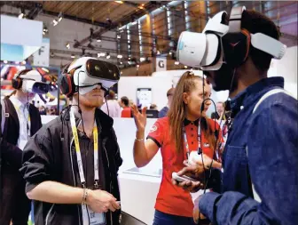  ?? CHARLES PLATIAU / REUTERS ?? Visitors use Lenovo Daydream View VR headsets during the Viva Tech startup and technology summit in Paris, France.