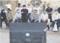  ?? (Majid Asgaripour/WANA/Reuters) ?? PEOPLE WATCH the debate of presidenti­al candidates, at a park in Tehran earlier this week.