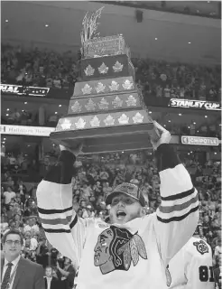  ?? ELISE AMENDOLA/ THE ASSOCIATED PRESS ?? Chicago Blackhawks right winger Patrick Kane hoists the Conn Smythe trophy, awarded annually to the most valuable player in the post-season.