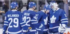 ?? CARLOS OSORIO/TORONTO STAR ?? Leafs William Nylander, Tyler Bozak and Matt Hunwick celebrate with goalie Frederik Andersen, who survived a late barrage in Tuesday’s win.