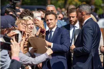  ?? XINHUA/VNA Photos ?? MAN OF THE MOMENT: French President Emmanuel Macron poses for photos with his supporters before casting his ballot in Le Touquet, northern France, April 24, 2022.