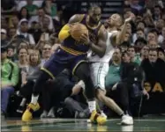  ?? ELISE AMENDOLA — THE ASSOCIATED PRESS ?? Cleveland Cavaliers forward LeBron James, left, muscles his way to the basket as Boston Celtics guard Avery Bradley, right, tries to defend on Friday.