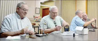  ?? Keith Bryant/The Weekly Vista ?? Dick Mairet, left, and Dave Winchell each work to tie a fly fishing lure while Owen Wilson and Alexander Alan-Brown work on one together.