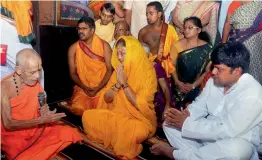  ?? — PTI ?? Rajasthan chief minister Vasundhara Raje with her son Dushyant Singh seek blessings of Sri Vishvesh Teertha Maharaj of Pejawar Mutt at Udupi in Karnataka on Monday.