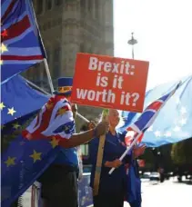  ?? - Reuters file photo ?? PROTEST: Anti-brexit protestors wave flags outside the Houses of Parliament in London, Britain.