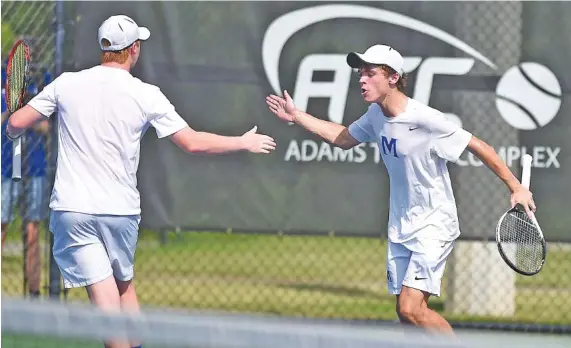  ?? STAFF PHOTO BY ROBIN RUDD ?? McCallie’s Jordan Bruck, left, and Will Leathers celebrate a doubles point during the Blue Tornado’s state-title victory over MBA on Wednesday in Murfreesbo­ro.