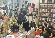  ?? PROVIDED TO CHINA DAILY WANG QIAN / CHINA DAILY ?? Above: Two women embrace following a talk event in the bookstore.
Left: