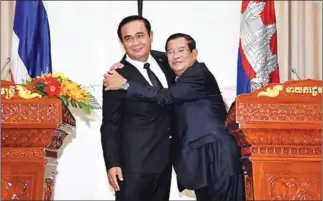  ?? GOVERNMENT HOUSE OF THAILAND ?? Prime Minister Hun Sen embraces Thai Prime Minister Prayut Chan-o-cha after a meeting at the Peace Palace in Phnom Penh yesterday.