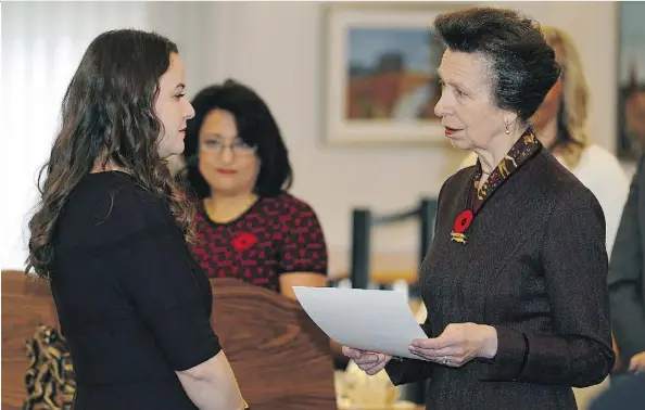  ?? LARRY WONG ?? Helen Cashman, left, received the Duke of Edinburgh’s Internatio­nal Award from Princess Anne at Government House on Wednesday.