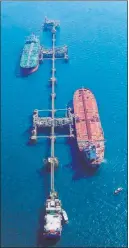  ?? The Associated Press ?? Nabil al-jurani
An aerial photo shows oil tankers loading crude oil Sunday at Iraq’s Al-basra Offshore Terminal in Basra, Iraq.