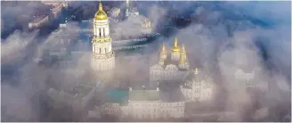  ?? THE ASSOCIATED PRESS ?? The 1,000-year-old Monastery of Caves, also known as Kiev Pechersk Lavra, the holiest site of Eastern Orthodox Christians, is seen through morning fog in Kiev, Ukraine.