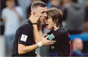  ?? REUTERS PIC ?? Croatia’s Ivan Perisic (left) and Luka Modric celebrate after their World Cup semi-final victory over England on Wednesday.