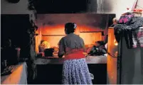  ?? ?? Lasanda cooks lunch for her family using firewood at home in Gonapola.