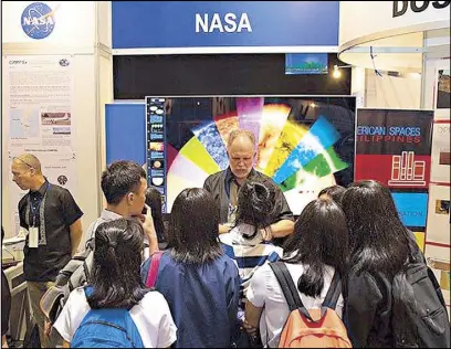  ??  ?? Photo provided by the US embassy shows NASA scientist Dr. Hal Maring answering questions from students during a recent National Science and Technology Week exhibit at the World Trade Center in Pasay City. NASA scientists are expected to return to Manila next year to work with Filipino scientists on a $20-million CAMP2Ex project that seeks to better understand the cloud formation in the western part of the Philippine­s. Story on Page 5.