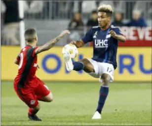  ?? MARK BLINCH — THE CANADIAN PRESS VIA AP ?? New England’s Juan Agudelo battles for the ball with Toronto FC’s Sebastian Giovinco during the second half Saturday in Toronto.