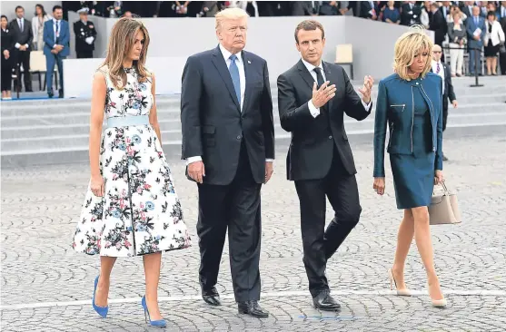  ?? Picture: AP. ?? French President Emmanuel Macron, second right, and his wife Brigitte Macron, right, walk with US president Donald Trump and First Lady Melania Trump after the Bastille Day military parade on the Champs Elysees in Paris.