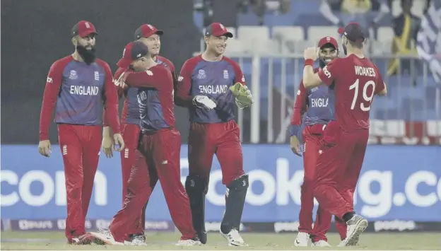  ?? ?? England’s Jos Buttler, centre, celebrates with teammates after the dismissal of Sri Lanka’s captain Dasun Shanaka, who Buttler ran out with a direct throw