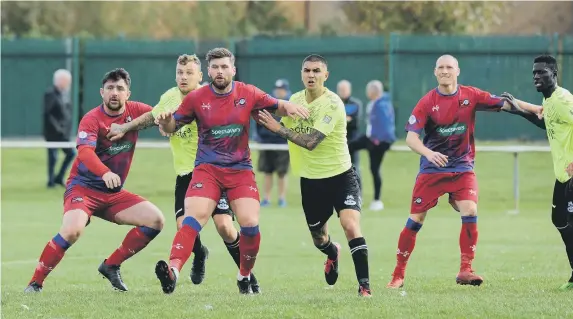  ??  ?? FC Hartlepool (red) and Wolviston lock horns in the Wearside League.