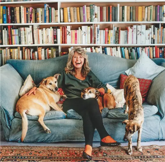  ??  ?? Jilly Cooper with her assorted canines of mixed ancestry in the 1980s. She took a break from sensationa­l fiction to pen Mongrel Magic