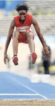  ?? RICARDO MAKYN/MULTIMEDIA PHOTO EDITOR ?? Michela Wilson of the Queen’s School competing in the girls’ Class Two long jump at the ISSA-GraceKenne­dy Boys and Girls’ Athletics Championsh­ips at the National Stadium yesterday.