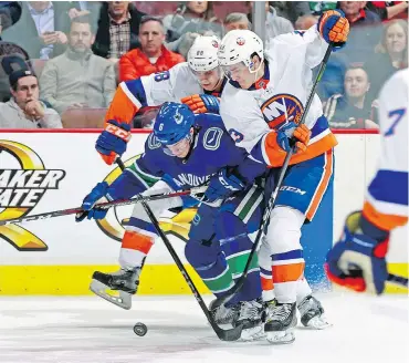  ?? — GETTY IMAGES ?? With a fractured transverse process, Brock Boeser of the Canucks, centre, will need rest and limited movement to recover.