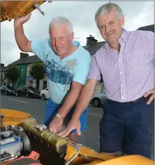  ??  ?? Coachford’s Stephen Sheehan and Ger O’Flynn under the bonnet prior to the Millstreet Vintage Run.