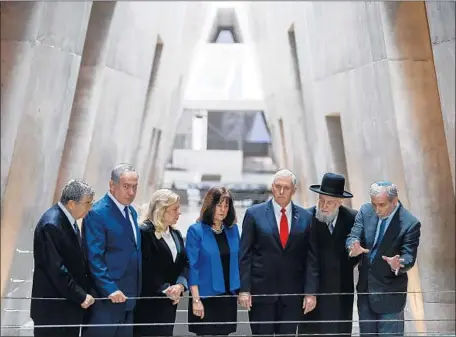  ?? Ronen Zvulun AFP/Getty Images ?? VICE PRESIDENT Mike Pence, in red tie, and wife Karen, center, visit Yad Vashem, Israel’s Holocaust memorial, with Israeli Prime Minister Benjamin Netanyahu, second from left, his wife, Sara, and others. Pence met a friendly leader in Israel, unlike in...