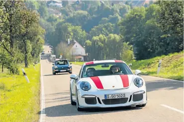  ??  ?? Driving through the German countrysid­e in the Porsche 911R. Left: The legendary icon that is the 964 Turbo and a possible future icon, the 911R.