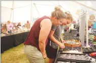  ?? ?? Amy Francis and her daughter, Piper, of Fayettevil­le, pick out some jewelry at the vendor booth, Fantasea, at the Clotheslin­e Fair over Labor Day weekend. Francis also was a vendor at the fair, offering handmade baby items, such as bibs and blankets, for sale.