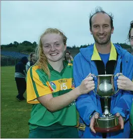  ??  ?? Ciara Byrne and Margaret Roche receive the cup from Serge Goetelan after they defeated Glenealy in the Senior league final.