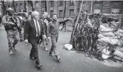  ?? Ukrainian Presidenti­al Press Office via AP ?? Ukrainian President Volodymyr Zelenskyy, center, and Britain’s Prime Minister Boris Johnson walk in downtown Kyiv, Ukraine, on Saturday.