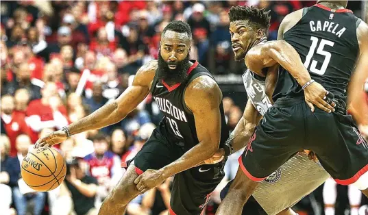  ?? TROY TAORMINA-USA TODAY SPORTS ?? PERKASA: Guard Houston Rockets James Harden (kiri) melewati kawalan pemain Minnesota Timberwolv­es Jimmy Butler yang dihadang Clint Capela di Toyota Center kemarin.