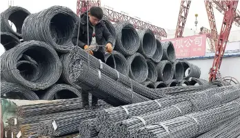  ??  ?? A worker loads steel products on to a vehicle at a steel market in Fuyang in central China’s Anhui province on March 2. The United States is ramping up its threats with plans for US$200b more tariffs against China.