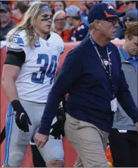  ?? DAVID ZALUBOWSKI — THE ASSOCIATED PRESS ?? Detroit Lions inside linebacker Alex Anzalone, left, who is tied for the team lead in tackles, walks off the filed after suffering an ankle injury during Sunday’s road loss to the Denver Broncos.