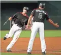  ?? MICHAEL CHOW/THE REPUBLIC ?? The Diamondbac­ks’ Nick Ahmed is greeted by third-base coach Tony Perezchica (8) after hitting a three-run homer Monday.