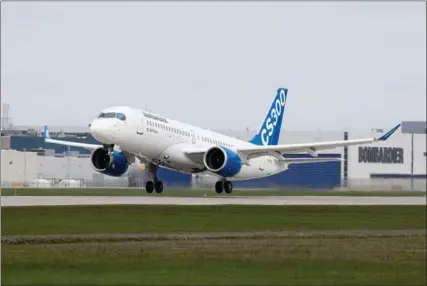  ?? TRIBUNE NEWS SERVICES FILE PHOTO ?? A Bombardier CS300 jet takes off. Under the company’s deal with Airbus, CSeries jets will be produced in an Airbus plant in Alabama.