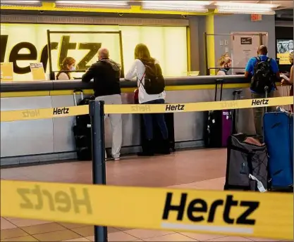  ?? Joe Raedle / Getty Images ?? Hertz announced Monday that it is buying 100,000 Teslas as the company is emerging from bankruptcy.