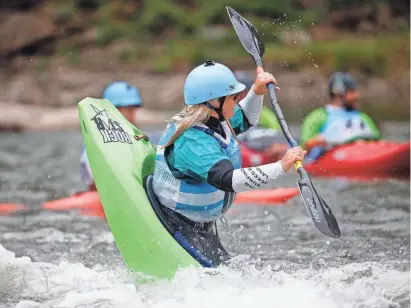  ?? PHOTOS BY BRYON HOULGRAVE/THE REGISTER ?? Kayaker Hannah Childs of Cedar Rapids competes during the Charles City Challenge kayak and standup paddle board contest June 26, 2021, at the Charles City Whitewater Park in Charles City.