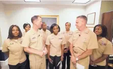  ?? U.S. NAVY/ASSOCIATED PRESS ?? Yeoman First Class LaToya Jones, center, speaks as Chief of Naval Operations Adm. John Richardson, left of center, and Chief of Naval Personnel Adm. Robert Burke, right of center, and others listen.