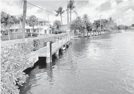  ?? SUSANNAH BRYAN/SOUTH FLORIDA SUN SENTINEL ?? Fort Lauderdale plans to remove 28 docks along Cordova Road in order to raise the seawall. Homeowner Bill Scherer, a high-powered attorney, says he spent thousands on this concrete dock and doesn’t want it removed.