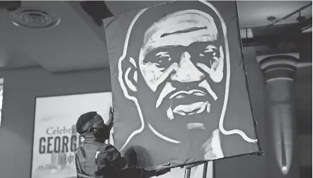  ?? DAVID J. PHILLIP/ AP POOL ?? A man draws an image of George Floyd during the funeral service for Floyd at The Fountain of Praise church in Houston in June.