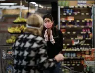  ??  ?? Khadija Zanotto helps a Zanotto’s market customer. “Instead of daily, small purchases for their meals, now it’s big baskets weekly,” she says about customers’ new shopping habits.