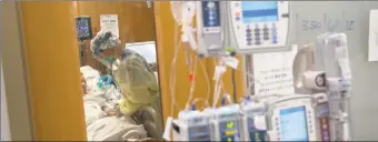  ?? John Moore / Getty Images ?? A nurse tends to a COVID- 19 patient last week in a Stamford Hospital Intensive Care Unit.