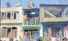  ?? PTI ?? People inspect a damaged house where four militants and a soldier were killed during an encounter at Shopian on Tuesday.