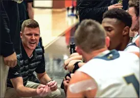  ?? TIM GODBEE / For the Calhoun Times ?? Calhoun coach Vince Layson (left) talks to his team during a timeout in the second half of Thursday’s game vs. Central (Macon).