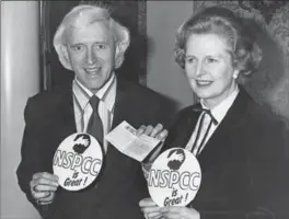  ?? EVENING STANDARD, HULTON ARCHIVE, GETTY IMAGES ?? Jimmy Savile with former British prime minister Margaret Thatcher at fundraisin­g presentati­on for the National Society for the Prevention of Cruelty to Children in 1980.