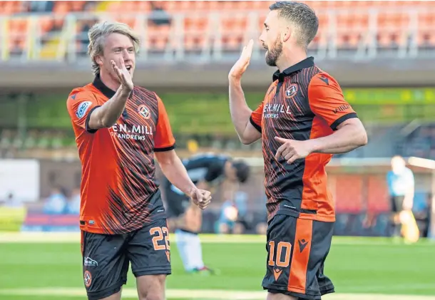  ??  ?? CITY SLICKERS: Kieran Freeman, left, congratula­tes Nicky Clark on his goal in the 6-1 drubbing of Elgin City at Tannadice in midweek.