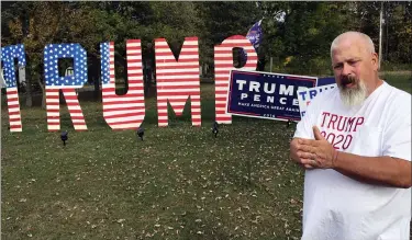  ?? JOHN SEEWER — THE ASSOCIATED PRESS ?? Mike Devore poses Oct. 14 near an 8-foot tall sign he made in his yard to show his support for President Donald Trump in Wayne. Devore lives in Wood County, an election bellwether that only once since 1964 has not picked the presidenti­al winner.