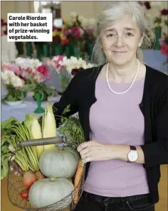  ??  ?? Carole Riordan with her basket of prize-winning vegetables.